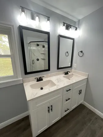 a bathroom with a double vanity sink and mirror