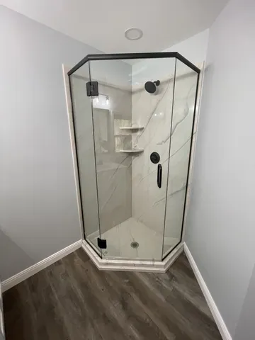 a bathroom with a glass shower door