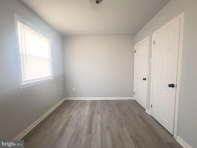a view of a room with wooden floor and window