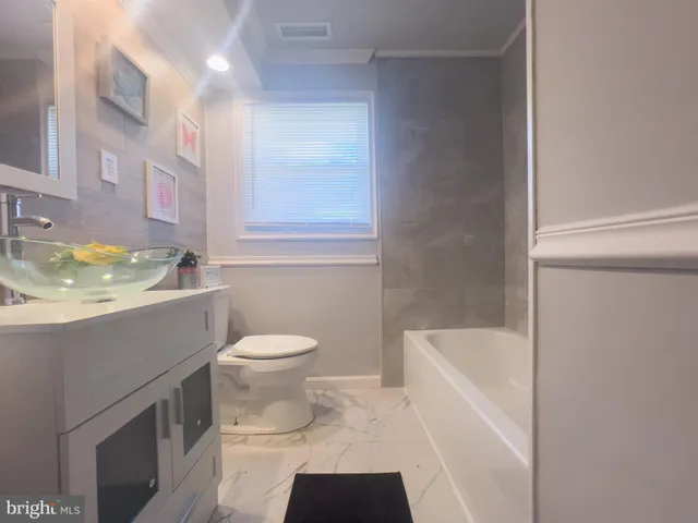 a bathroom with a sink a toilet and bathtub