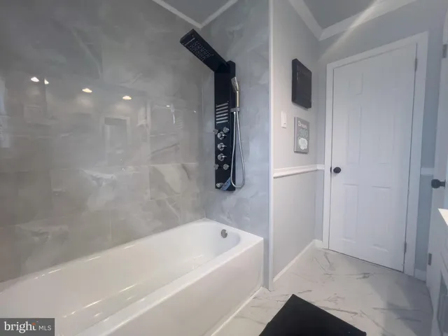 a bathroom with a bathtub and shower