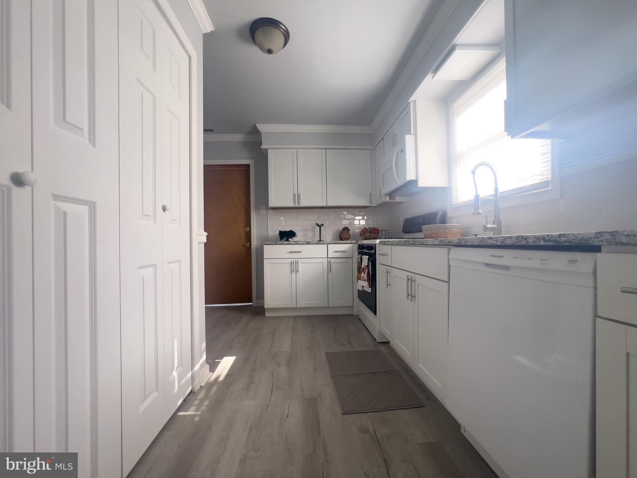 384 Windsor Drive Bellmawr, NJ 08031 - Photo 6 of 23 a kitchen with a sink window and cabinets