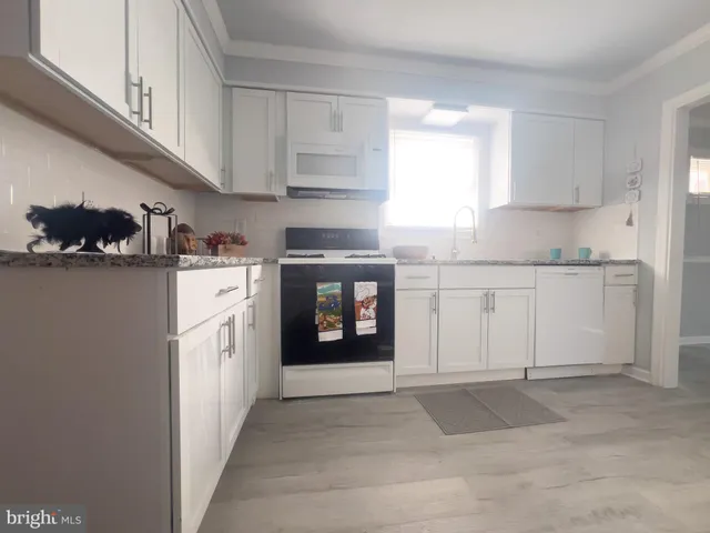 a kitchen with stainless steel appliances granite countertop a stove and a refrigerator
