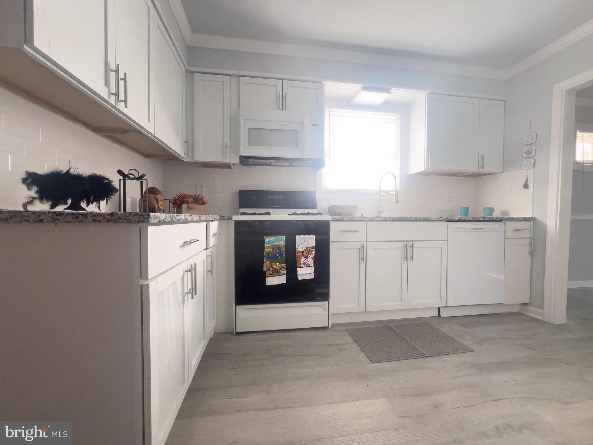 384 Windsor Drive Bellmawr, NJ 08031 - Photo 8 of 23 a kitchen with stainless steel appliances granite countertop a stove and a refrigerator