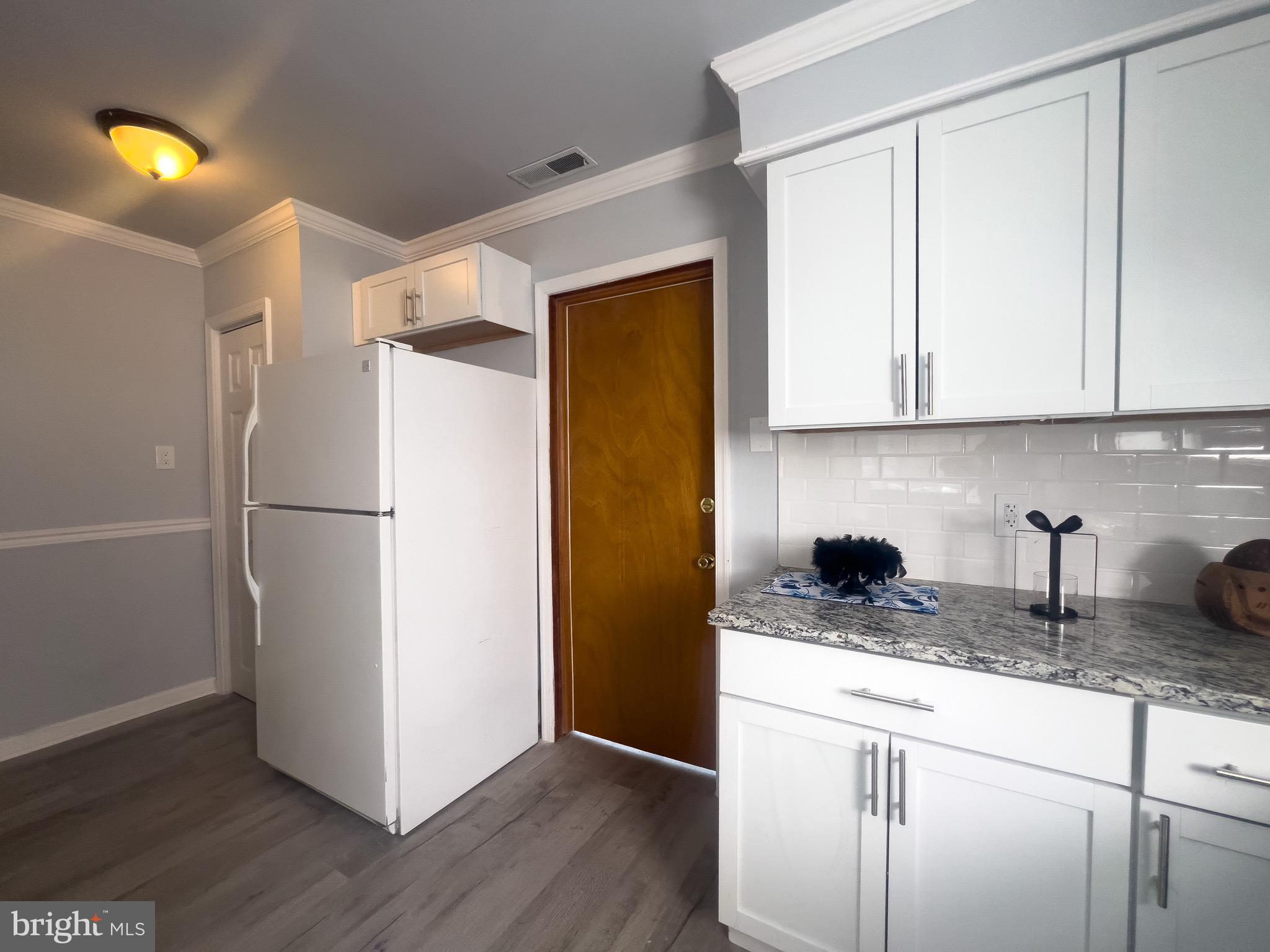 384 Windsor Drive Bellmawr, NJ 08031 - Photo 9 of 23 a kitchen with a refrigerator and a stove top oven