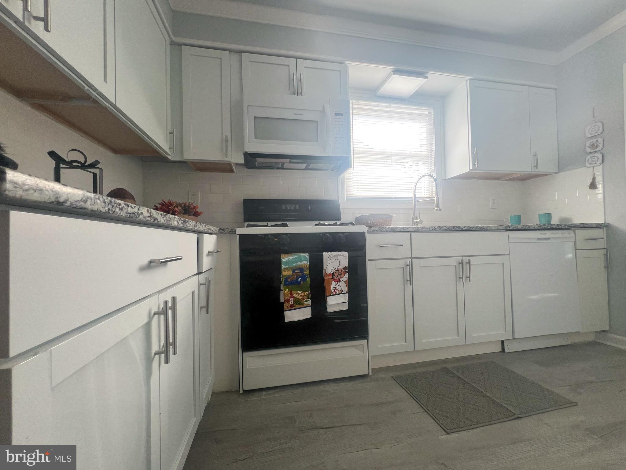 384 Windsor Drive Bellmawr, NJ 08031 - Photo 10 of 23 a kitchen with white cabinets and sink