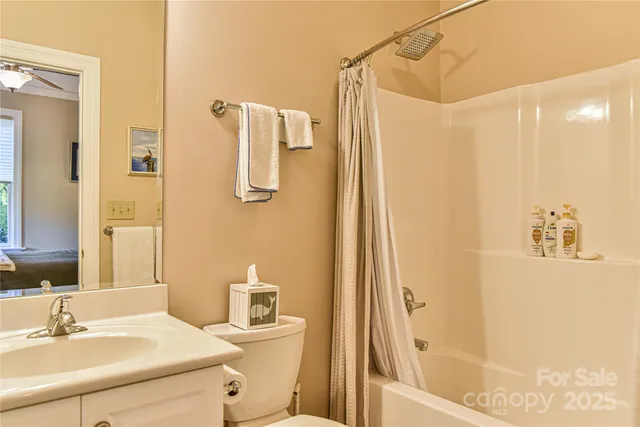 a bathroom with a sink shower and a mirror
