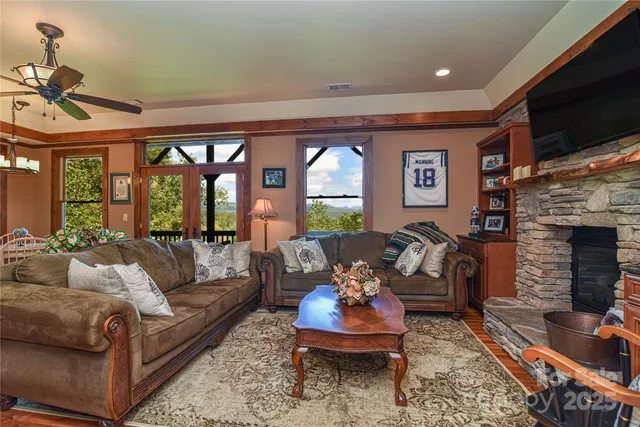 a living room with furniture a flat screen tv and a fireplace