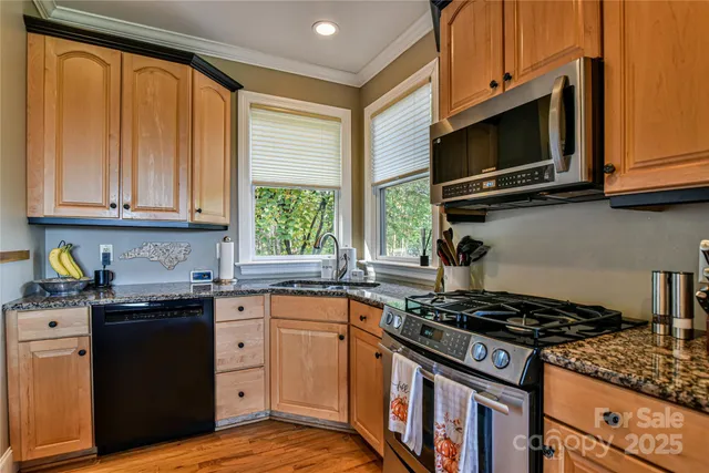 a kitchen with stainless steel appliances a stove sink and microwave