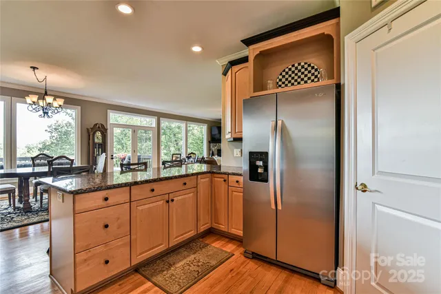 a kitchen with stainless steel appliances granite countertop a refrigerator and a sink
