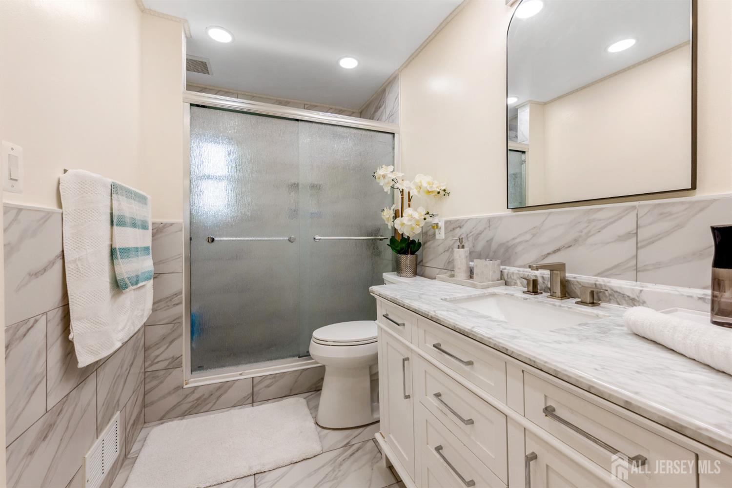 115 Vernon Way Port Reading, NJ 07064 - Photo 12 of 33 a bathroom with a granite countertop sink a toilet and shower