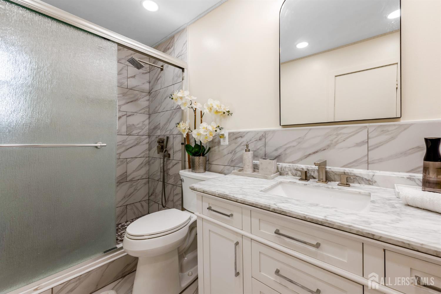 115 Vernon Way Port Reading, NJ 07064 - Photo 13 of 33 a bathroom with a granite countertop sink toilet and shower