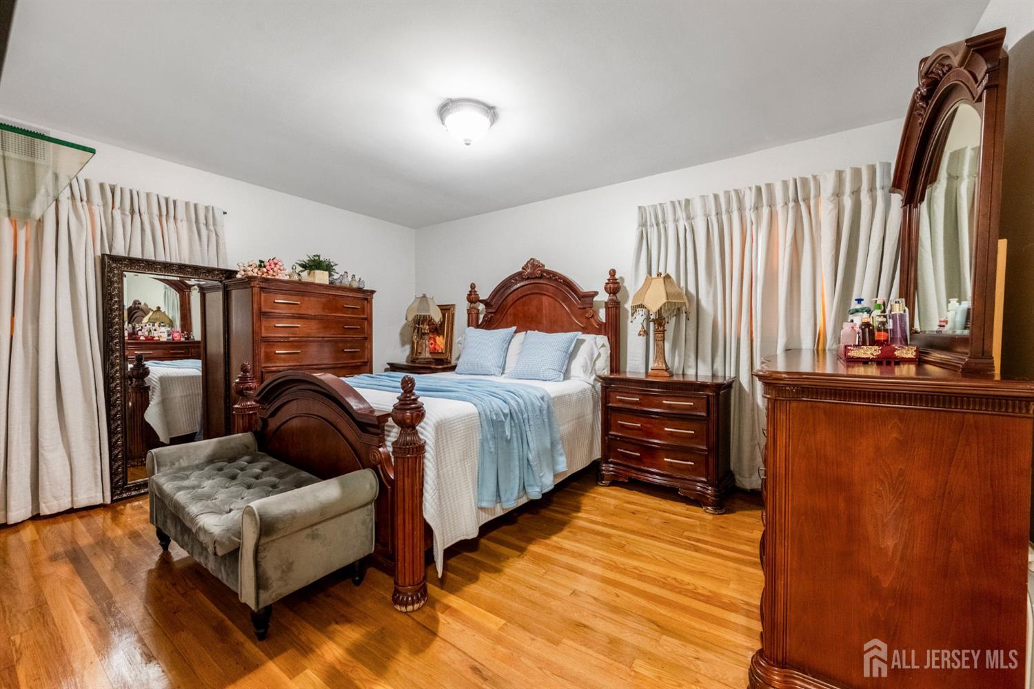 115 Vernon Way Port Reading, NJ 07064 - Photo 14 of 33 a bedroom with furniture and a window