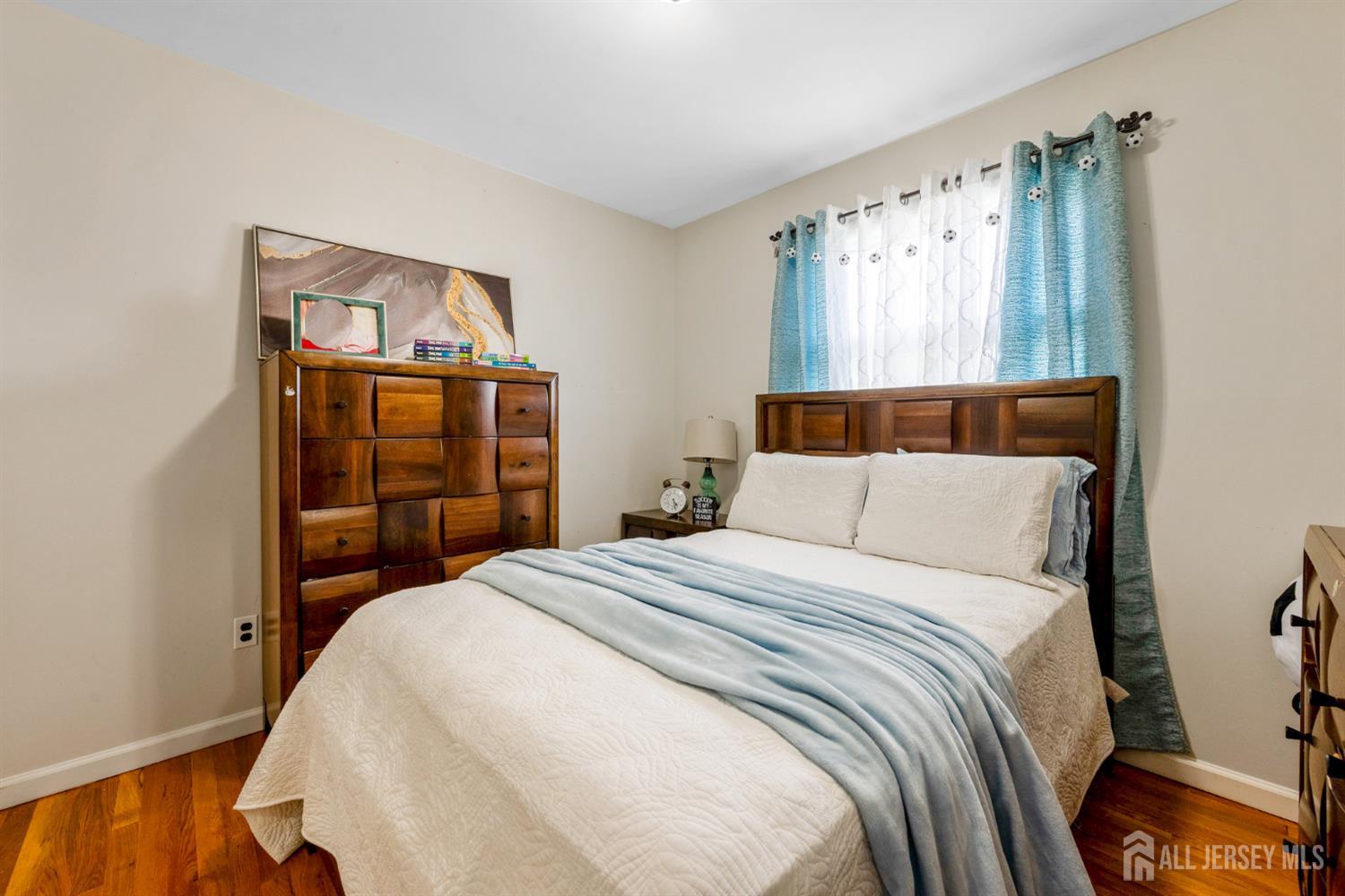 115 Vernon Way Port Reading, NJ 07064 - Photo 17 of 33 a bedroom with a bed and a window