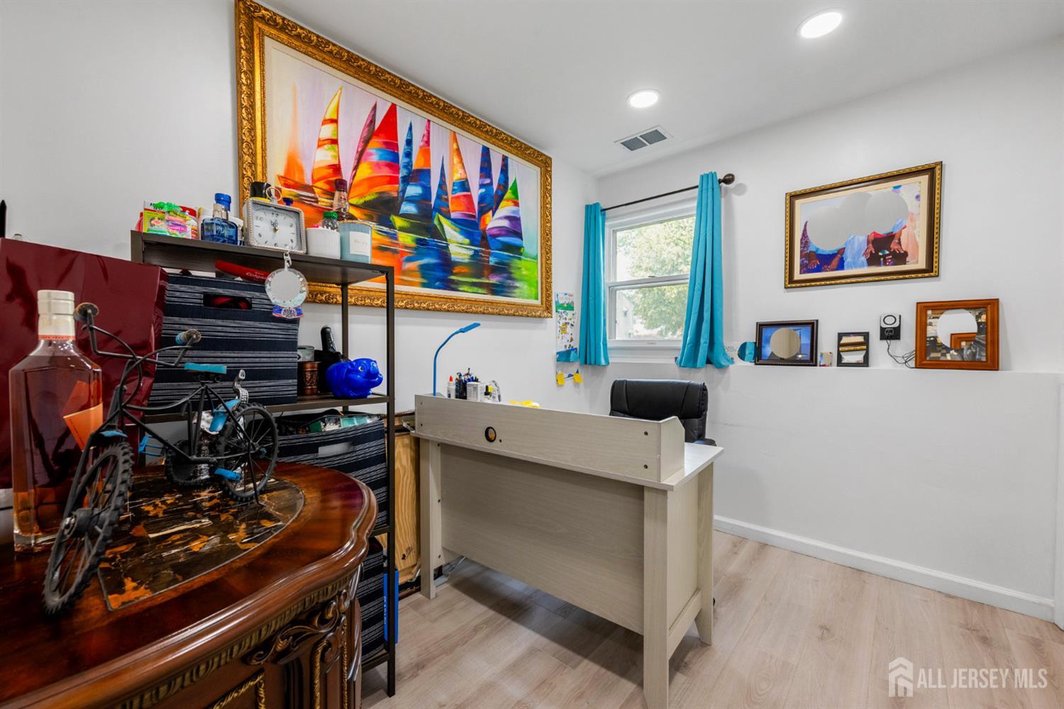 115 Vernon Way Port Reading, NJ 07064 - Photo 19 of 33 a room with furniture a flat screen tv and a window