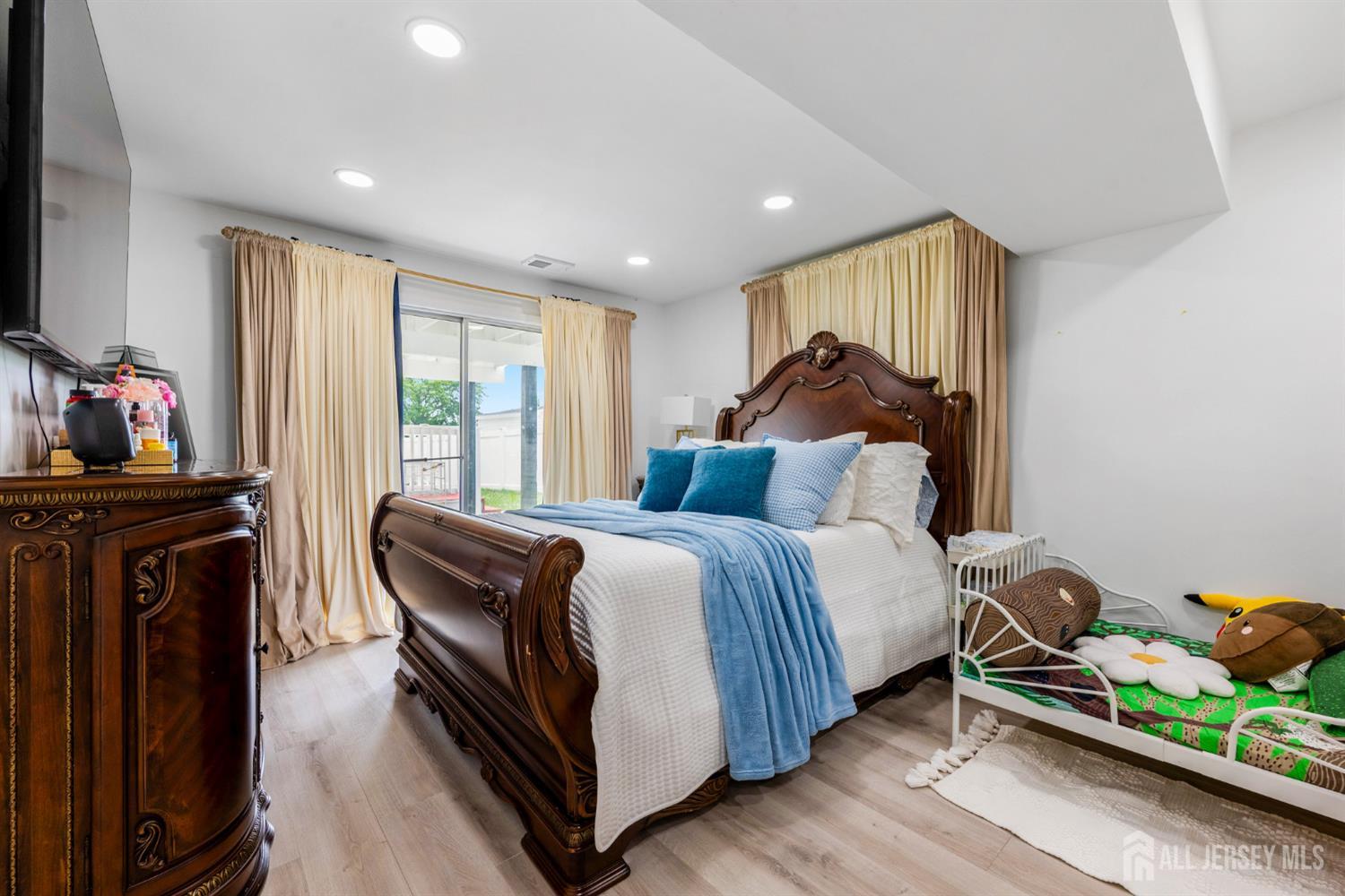 115 Vernon Way Port Reading, NJ 07064 - Photo 22 of 33 a bed room with a bed and two large window