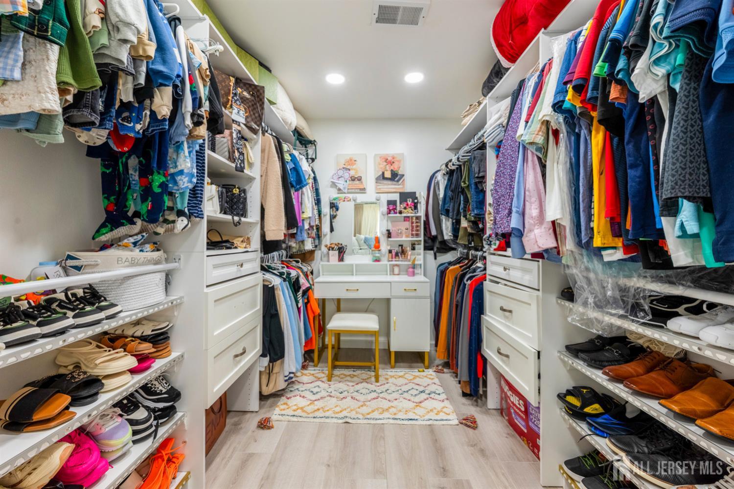 115 Vernon Way Port Reading, NJ 07064 - Photo 24 of 33 a view of walk in closet with clothes and shoes