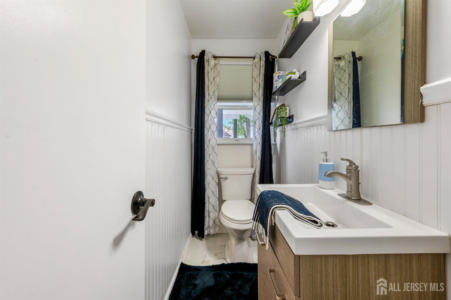 115 Vernon Way Port Reading, NJ 07064 - Photo 25 of 33 a bathroom with a sink and mirror