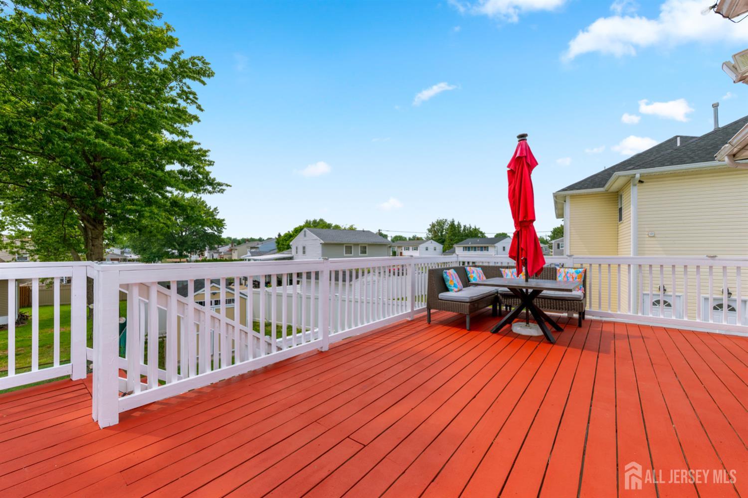 115 Vernon Way Port Reading, NJ 07064 - Photo 32 of 33 a view of a deck with wooden floor and outdoor seating