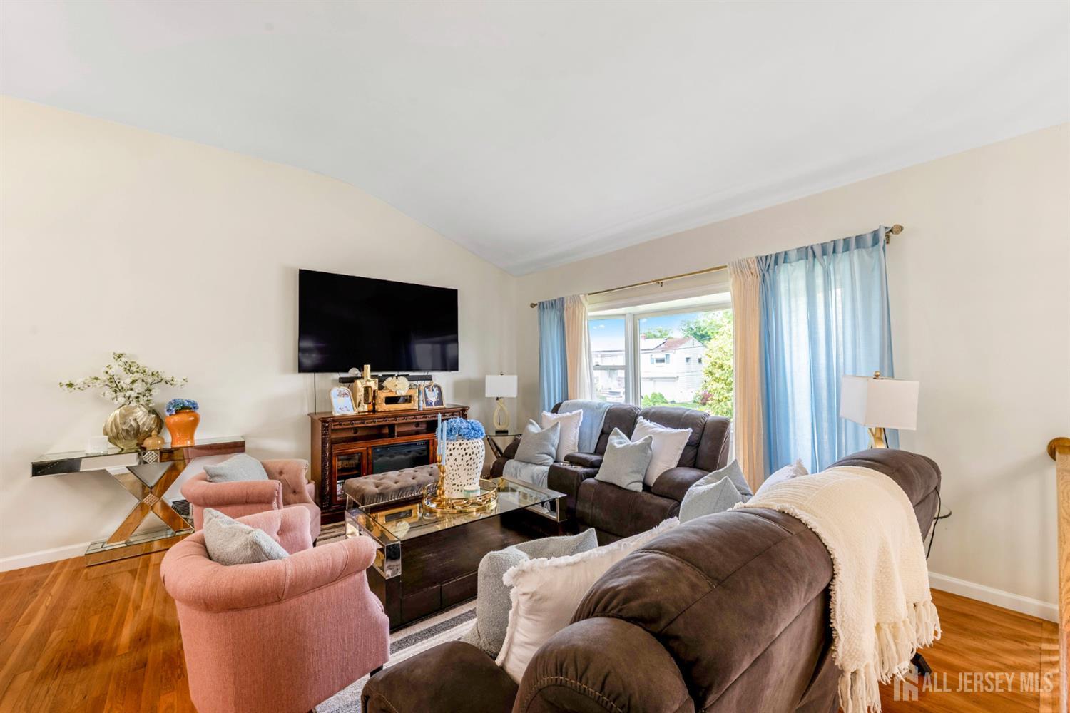 115 Vernon Way Port Reading, NJ 07064 - Photo 6 of 33 a living room with furniture and a flat screen tv