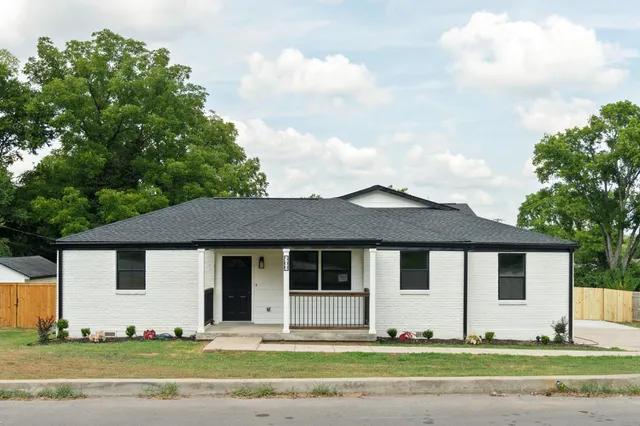 a front view of a house with a garden