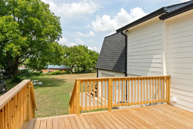 a view of a balcony with wooden floor and fence