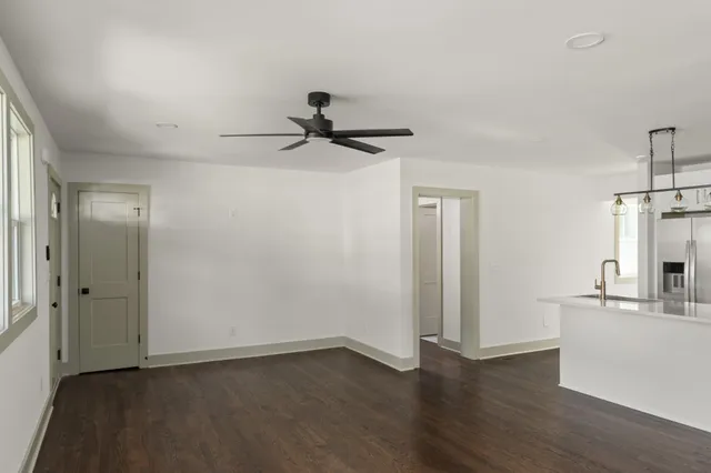 a view of a kitchen with a sink and a wooden floor