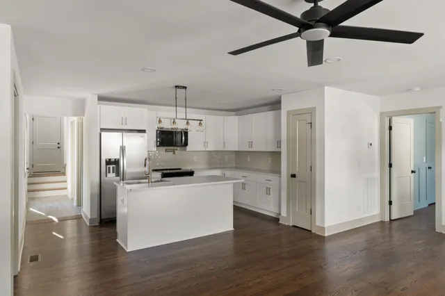a kitchen with stainless steel appliances a refrigerator and a stove