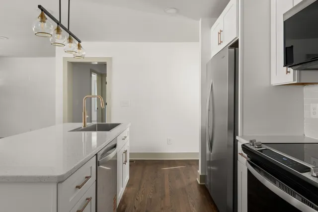 a kitchen with a sink and stainless steel appliances