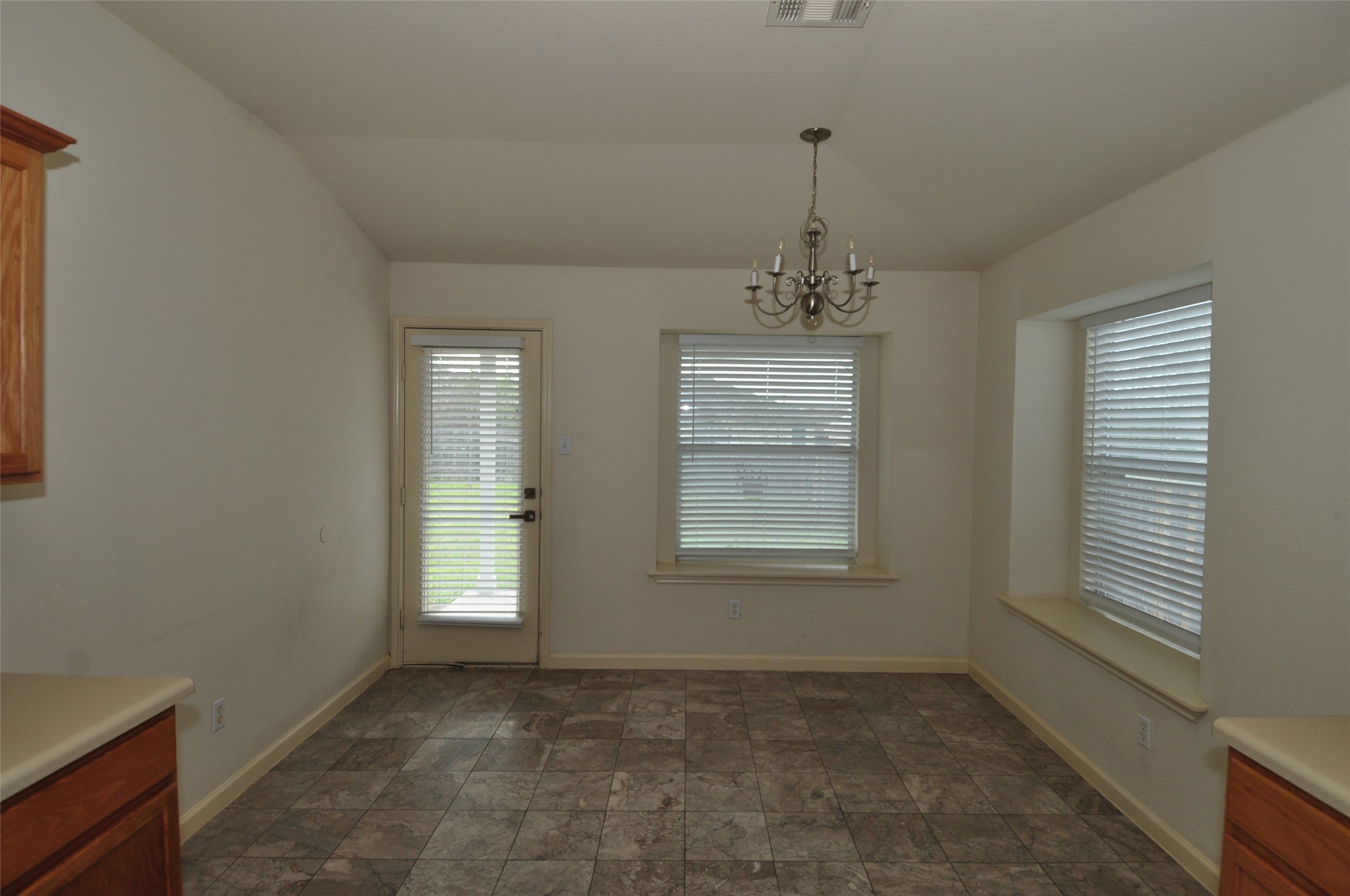 1409 Tea Leaf Drive Pflugerville, TX 78660 - Photo 6 of 18 A well-lit breakfast area with durable tile flooring and direct outdoor access.