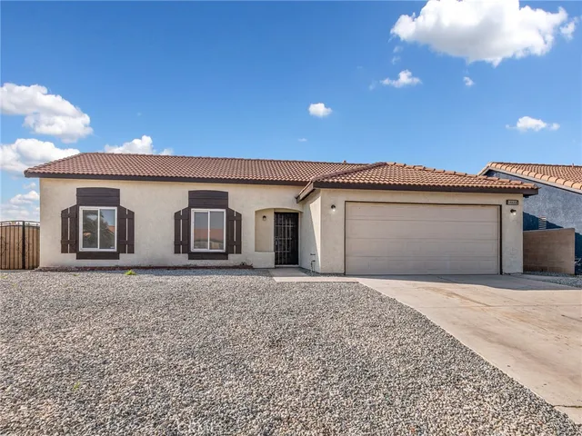 a front view of a house with yard and garage