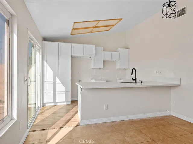 a kitchen with stainless steel appliances a sink a window and a counter top space