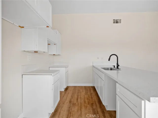 a close view of a sink and dishwasher with kitchen view