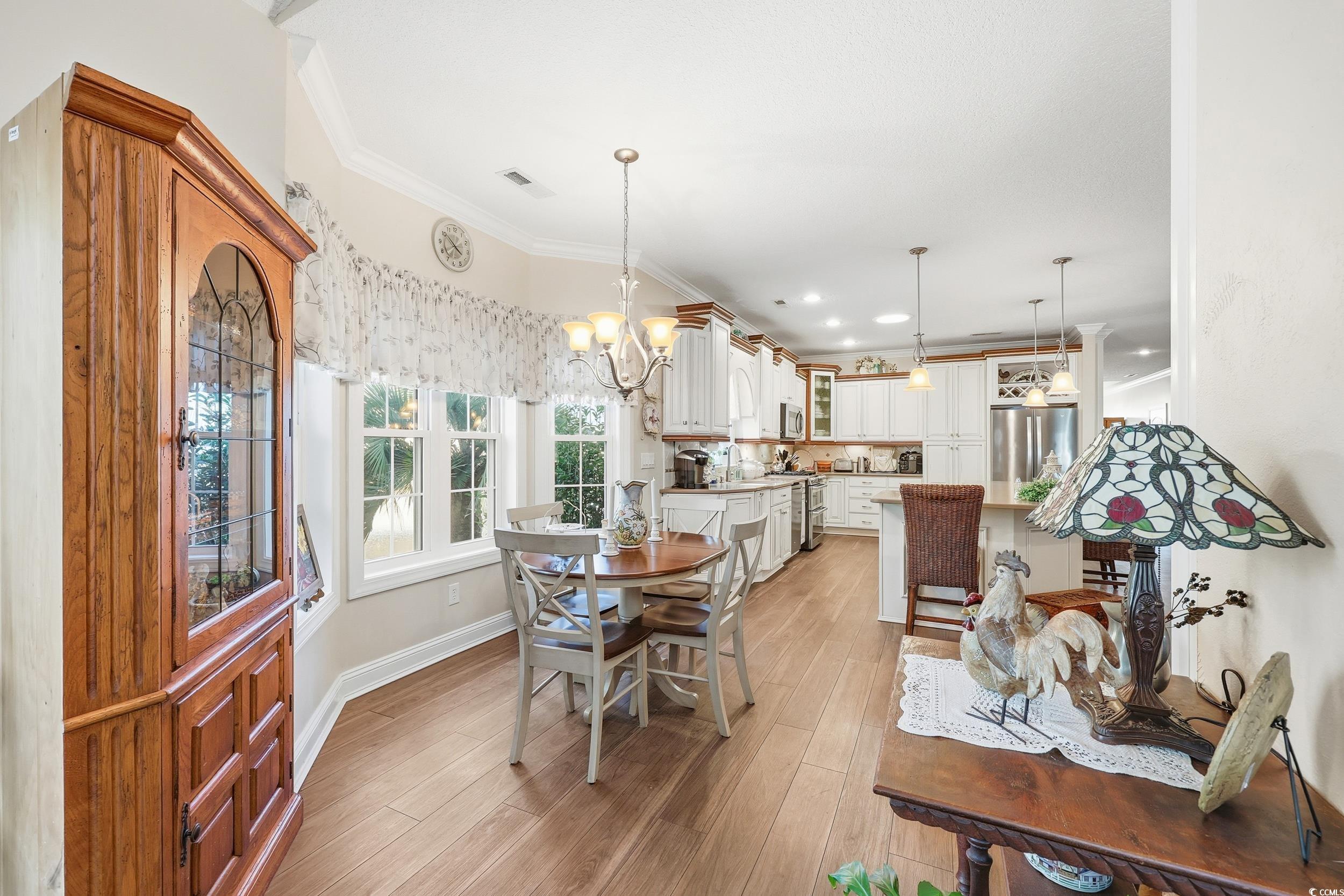 452 Deer Watch Circle Longs, SC 29568 - Photo 15 of 39 Dining room featuring a chandelier, light wood finished floors, crown molding, and recessed lighting