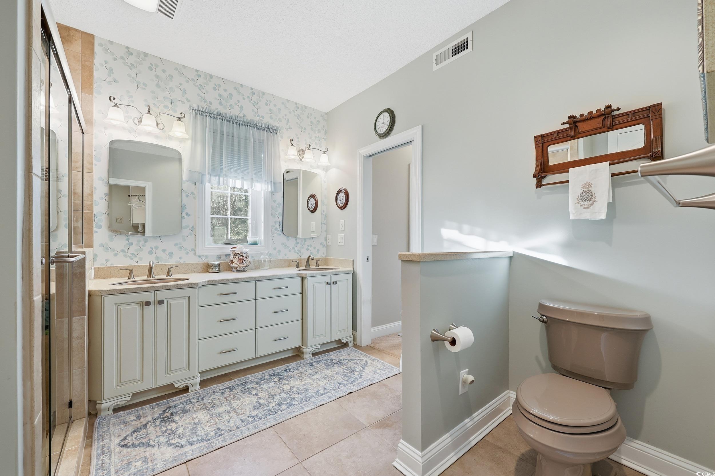 452 Deer Watch Circle Longs, SC 29568 - Photo 22 of 39 Main level primary bathroom with double vanity and a walk in shower.