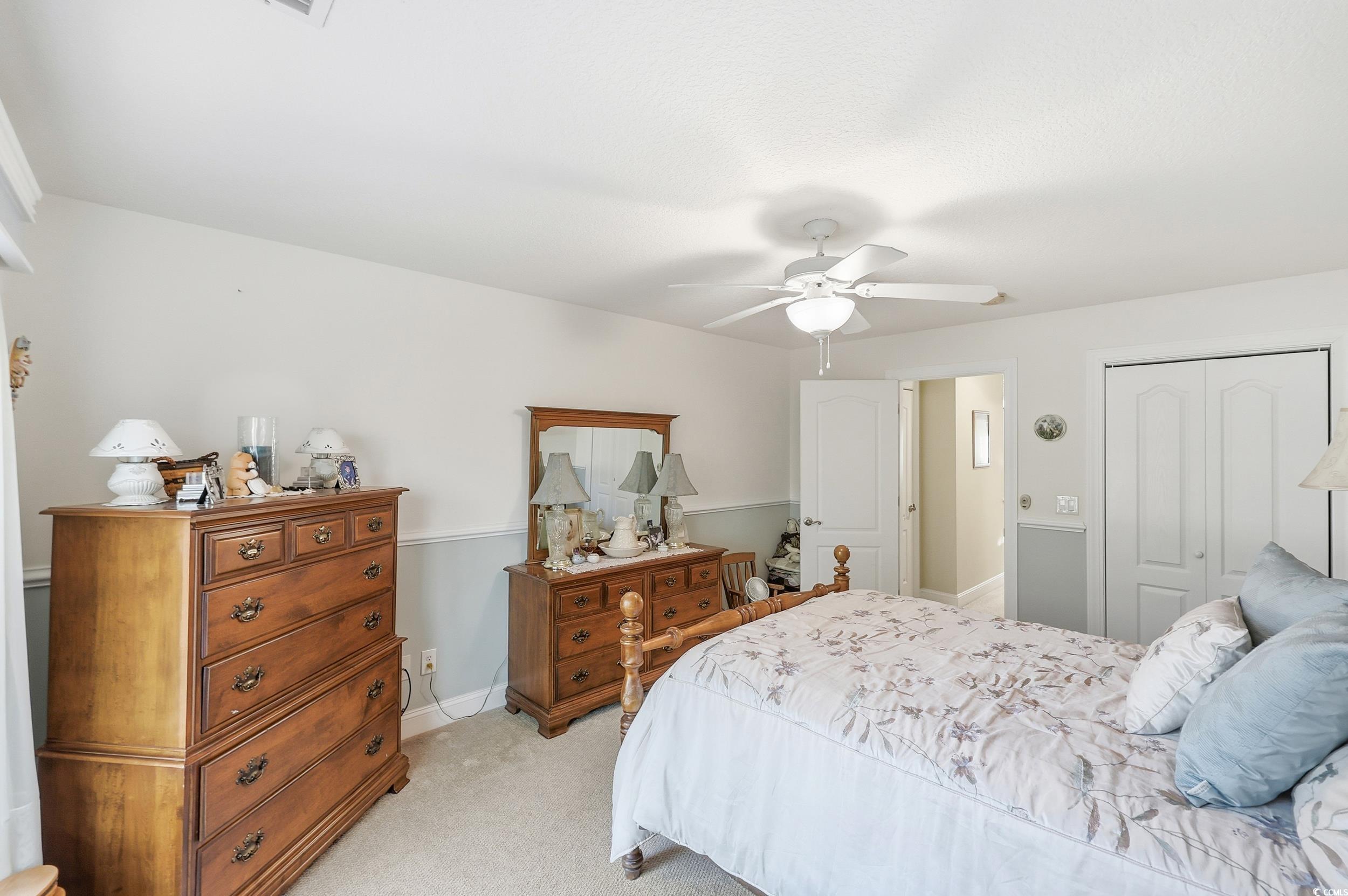 452 Deer Watch Circle Longs, SC 29568 - Photo 24 of 39 Bedroom with light colored carpet, ceiling fan, and a closet