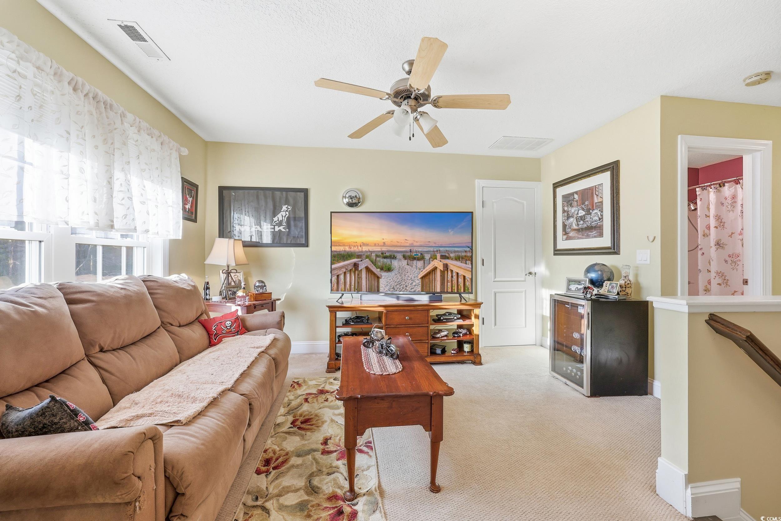 452 Deer Watch Circle Longs, SC 29568 - Photo 26 of 39 Loft living room featuring carpet and ceiling fan