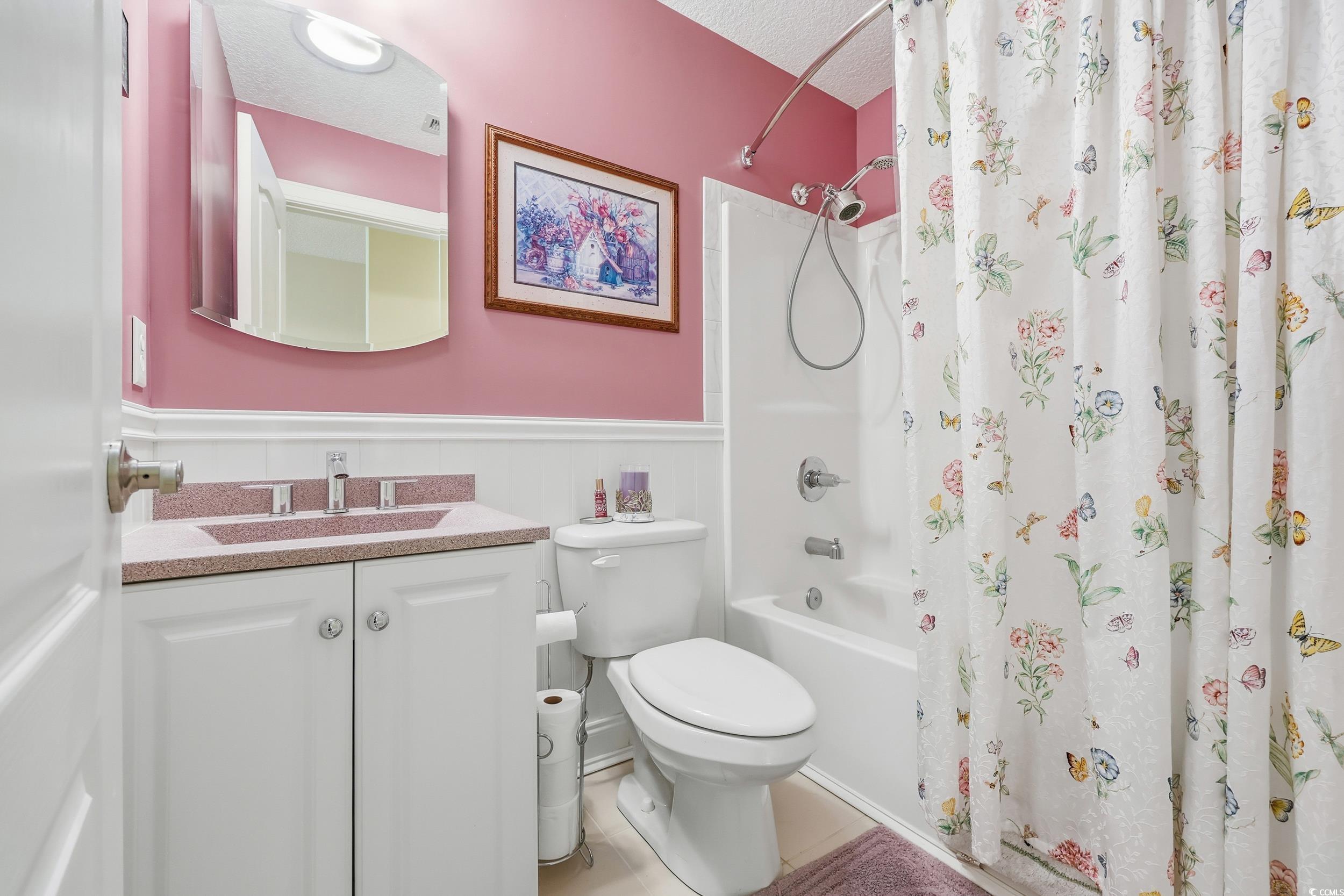 452 Deer Watch Circle Longs, SC 29568 - Photo 28 of 39 Bathroom featuring wainscoting, shower / tub combo, vanity, and a textured ceiling