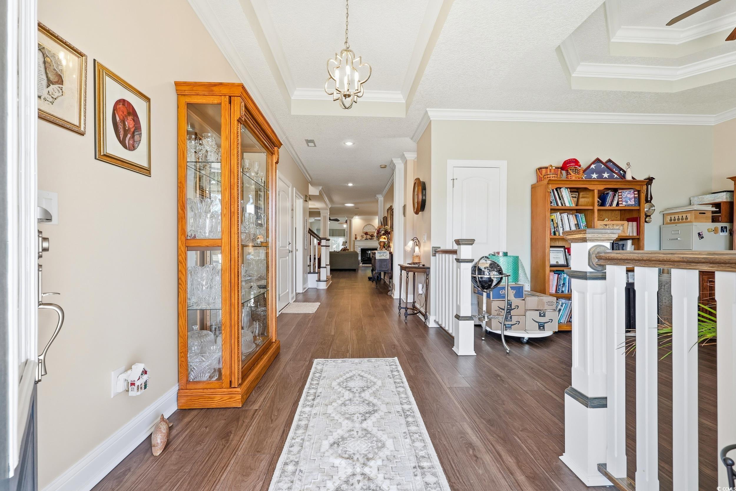452 Deer Watch Circle Longs, SC 29568 - Photo 4 of 39 Foyer entrance featuring a tray ceiling, dark wood-style flooring, ornamental molding, a chandelier, and stairway