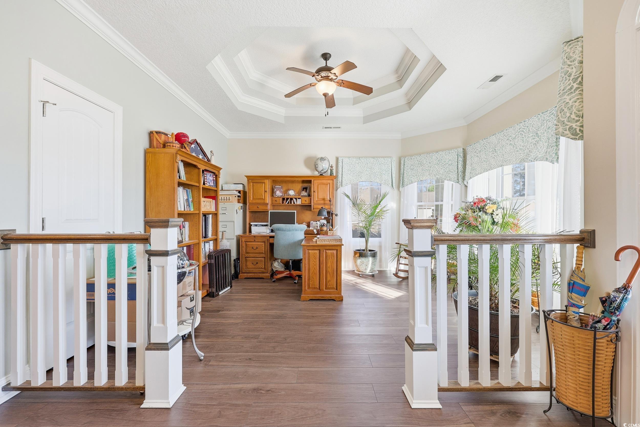452 Deer Watch Circle Longs, SC 29568 - Photo 5 of 39 Home office featuring a raised ceiling, crown molding, ceiling fan, and dark wood-style flooring