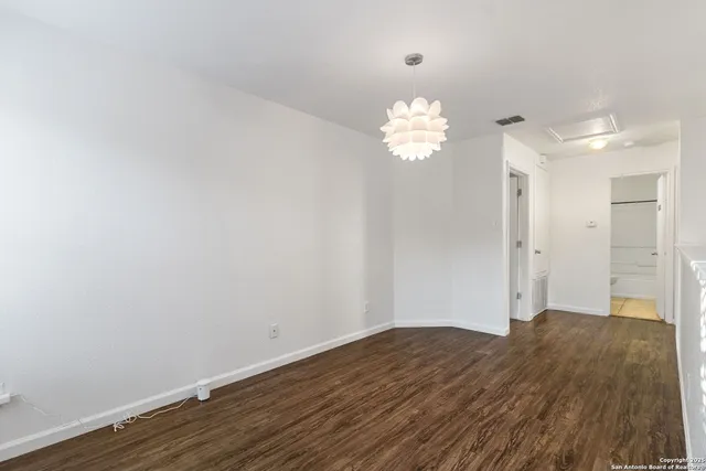 a view of a chandelier fan and wooden floor