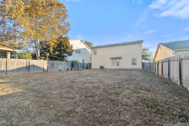 a view of a house with a backyard
