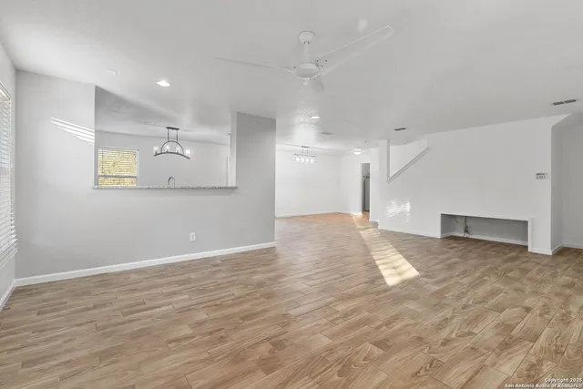 a view of an empty room with wooden floor