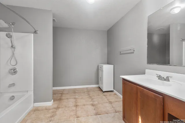 a bath room with a sink and a bath tub