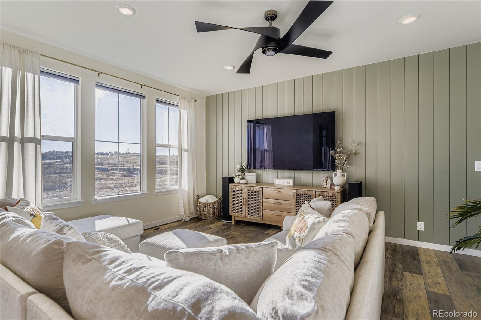 1126 Williams Loop Elizabeth, CO 80107 - Photo 16 of 50 a living room with furniture and a flat screen tv
