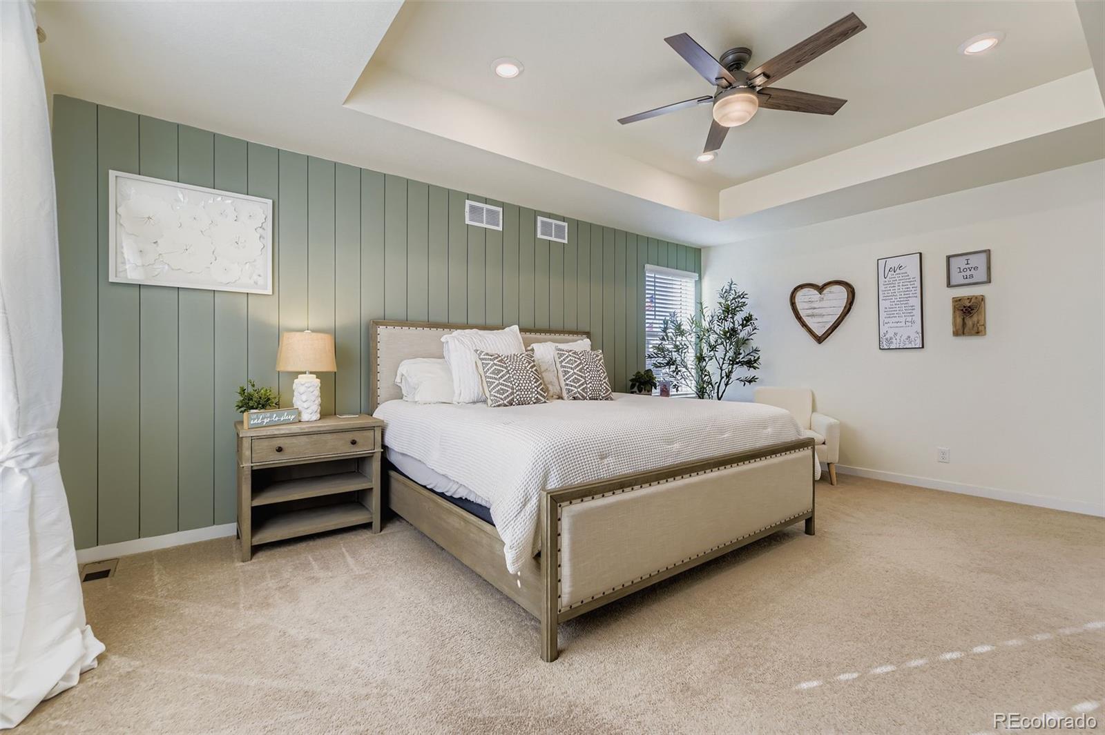 1126 Williams Loop Elizabeth, CO 80107 - Photo 20 of 50 a bedroom with a bed and a chandelier