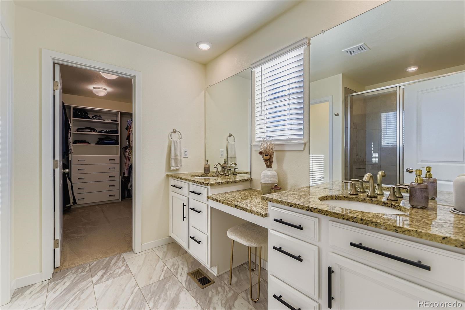 1126 Williams Loop Elizabeth, CO 80107 - Photo 21 of 50 a spacious bathroom with a granite countertop sink and a mirror