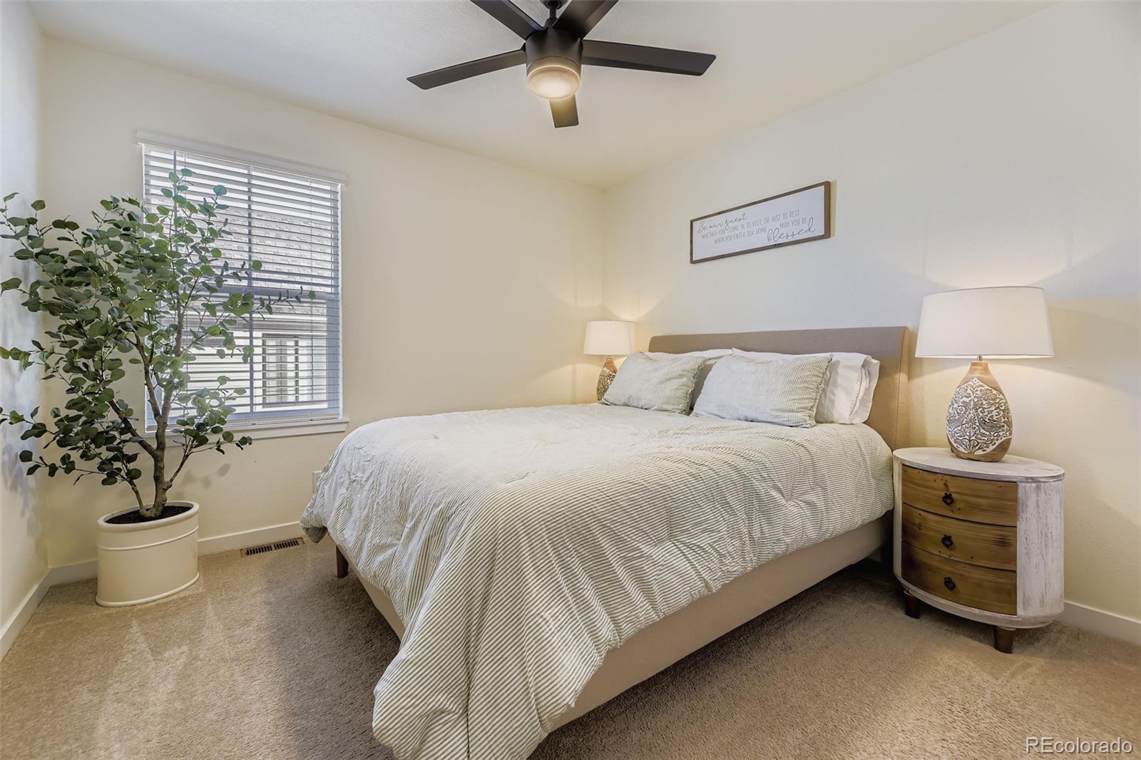 1126 Williams Loop Elizabeth, CO 80107 - Photo 25 of 50 a bedroom with a bed and a potted plant