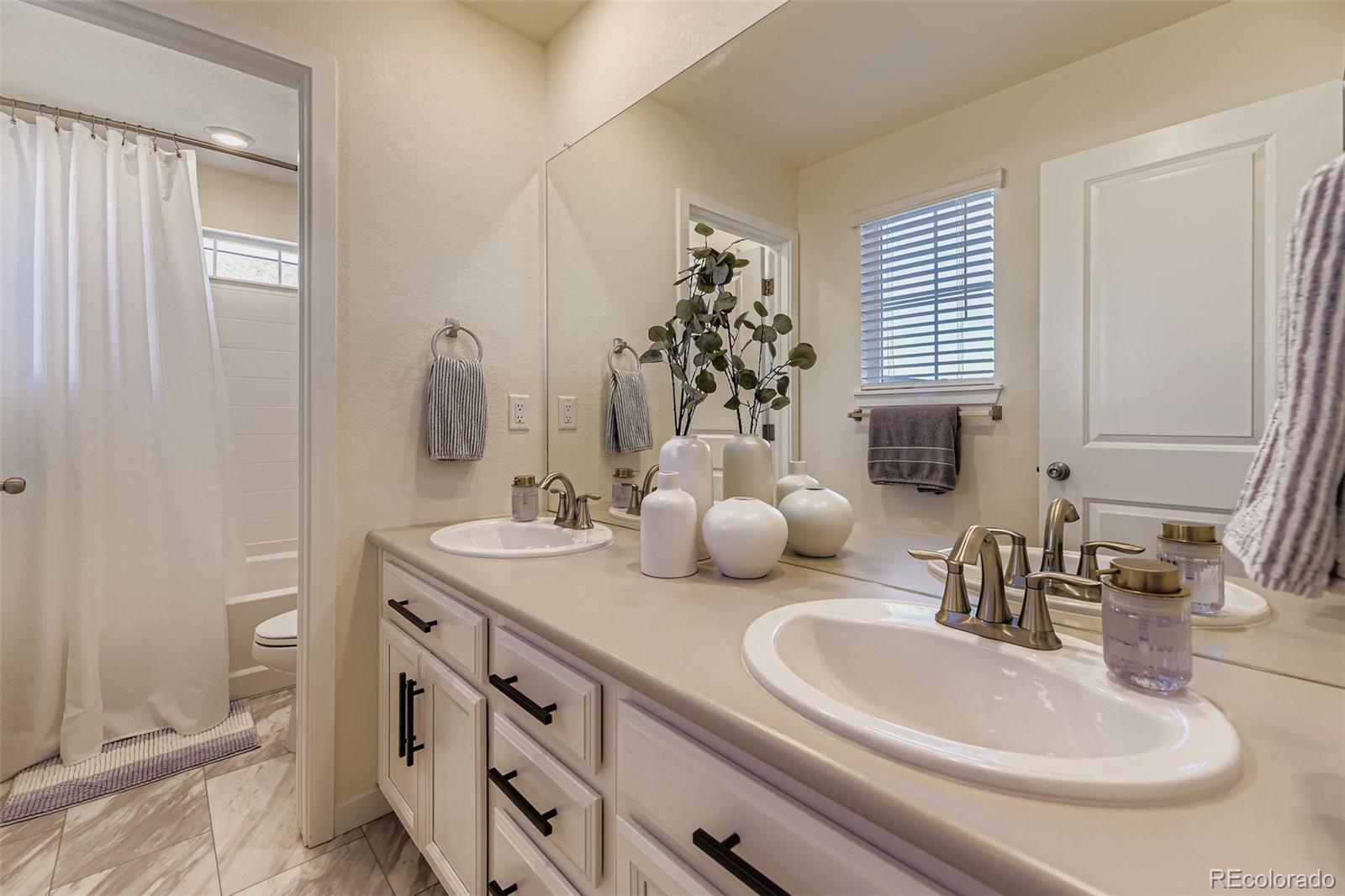 1126 Williams Loop Elizabeth, CO 80107 - Photo 27 of 50 a bathroom with double vanity and a mirror