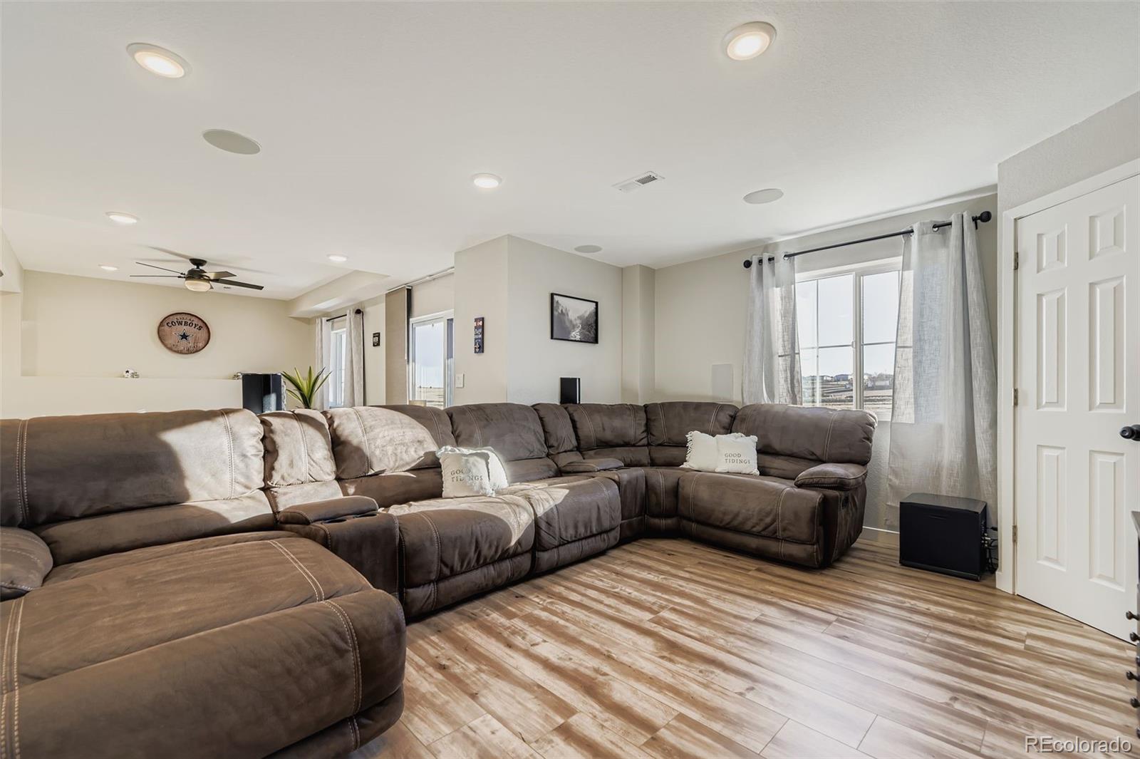 1126 Williams Loop Elizabeth, CO 80107 - Photo 29 of 50 a living room with couches and painted walls with wooden floor